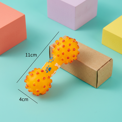 Orange squeaky dumbbell dog toy with plain kraft packaging on aqua background