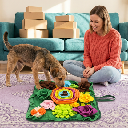 Woman supervising a dog exploring a colorful floral snuffle mat at home