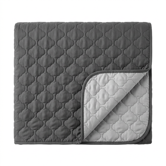 Single folded reversible charcoal and silver gray quilted pet sofa cover on white
